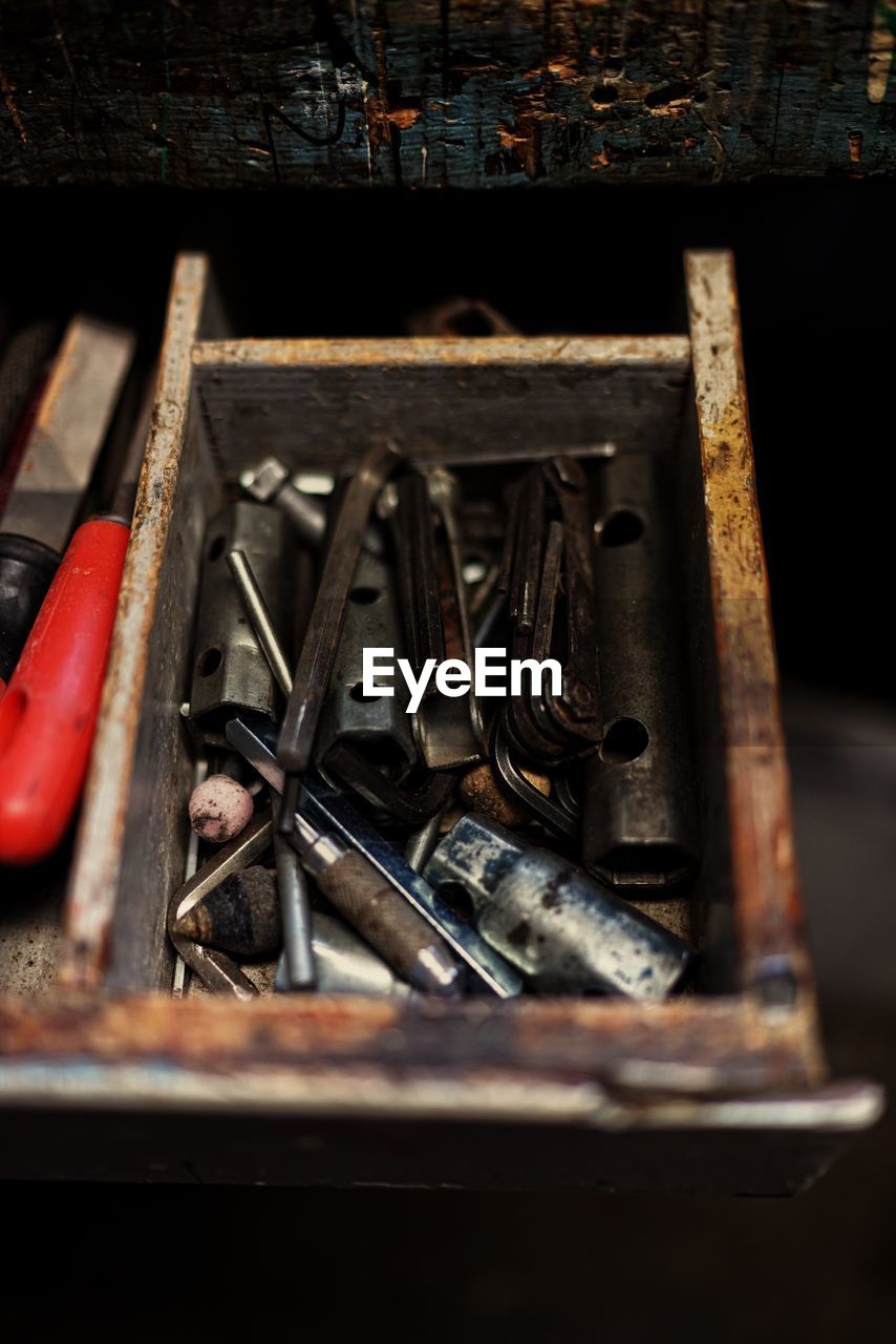 High angle view of tools in wooden container