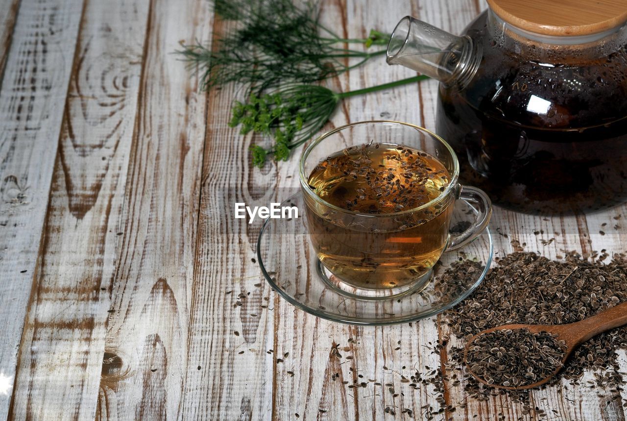 food and drink, wood, food, indoors, table, high angle view, drink, herb, plant, no people, tea, refreshment, freshness, wellbeing, hot drink, healthy eating, spice, household equipment, still life, kitchen utensil, studio shot