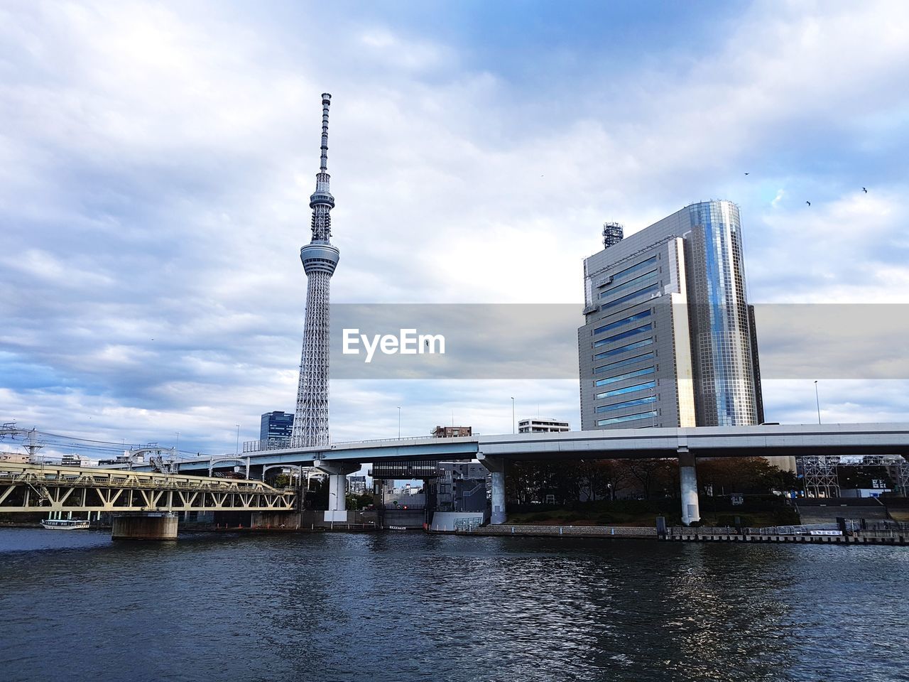 Bridge over river with buildings in background