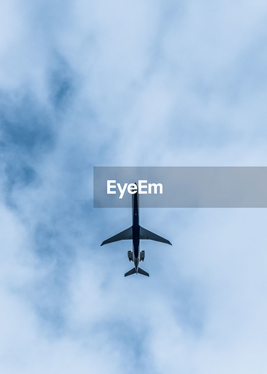 Low angle view of airplane flying in sky