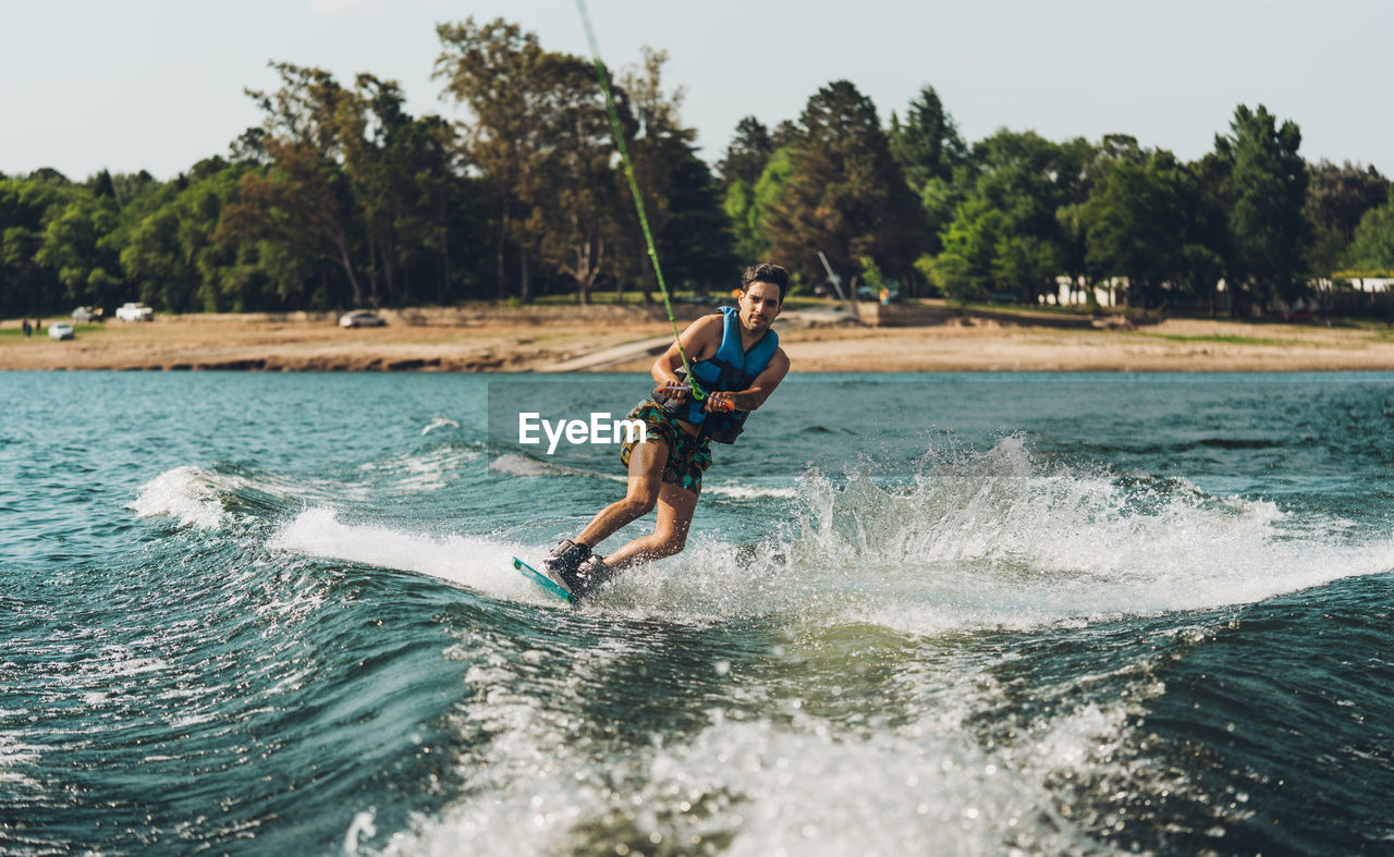 Full length of man doing wakeboard in a lake