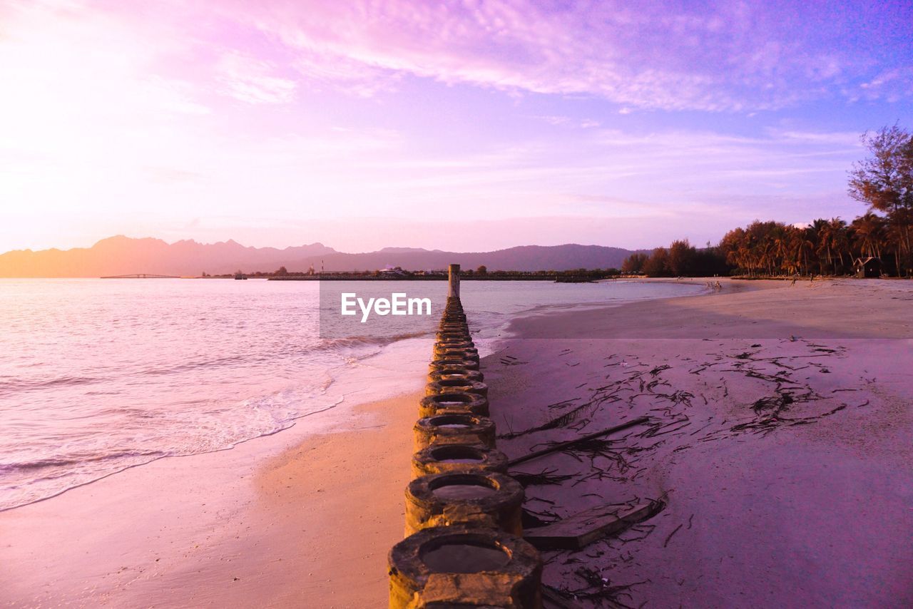 Scenic view of beach against sky during sunset