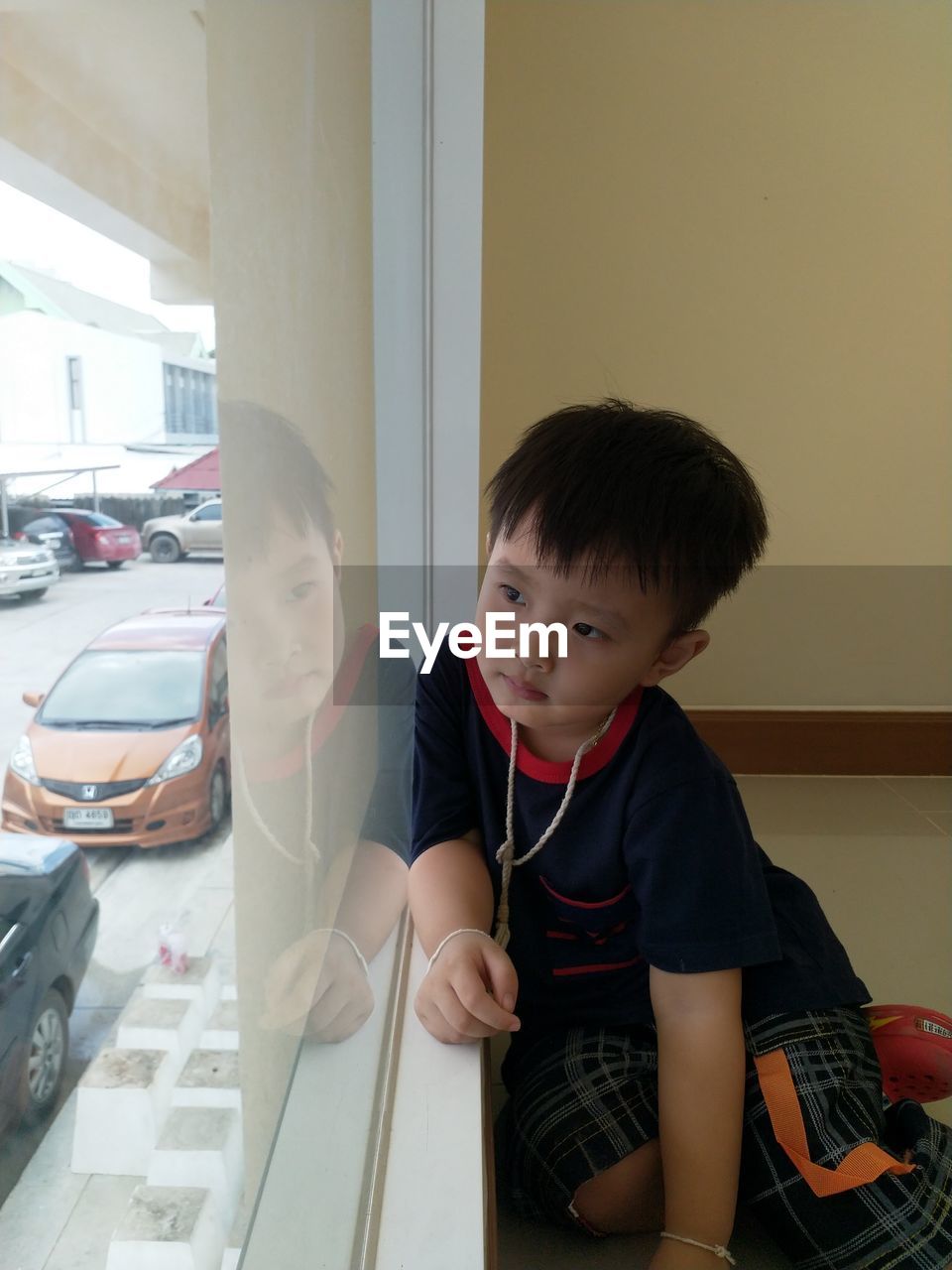 FULL LENGTH PORTRAIT OF BOY SITTING IN CAR