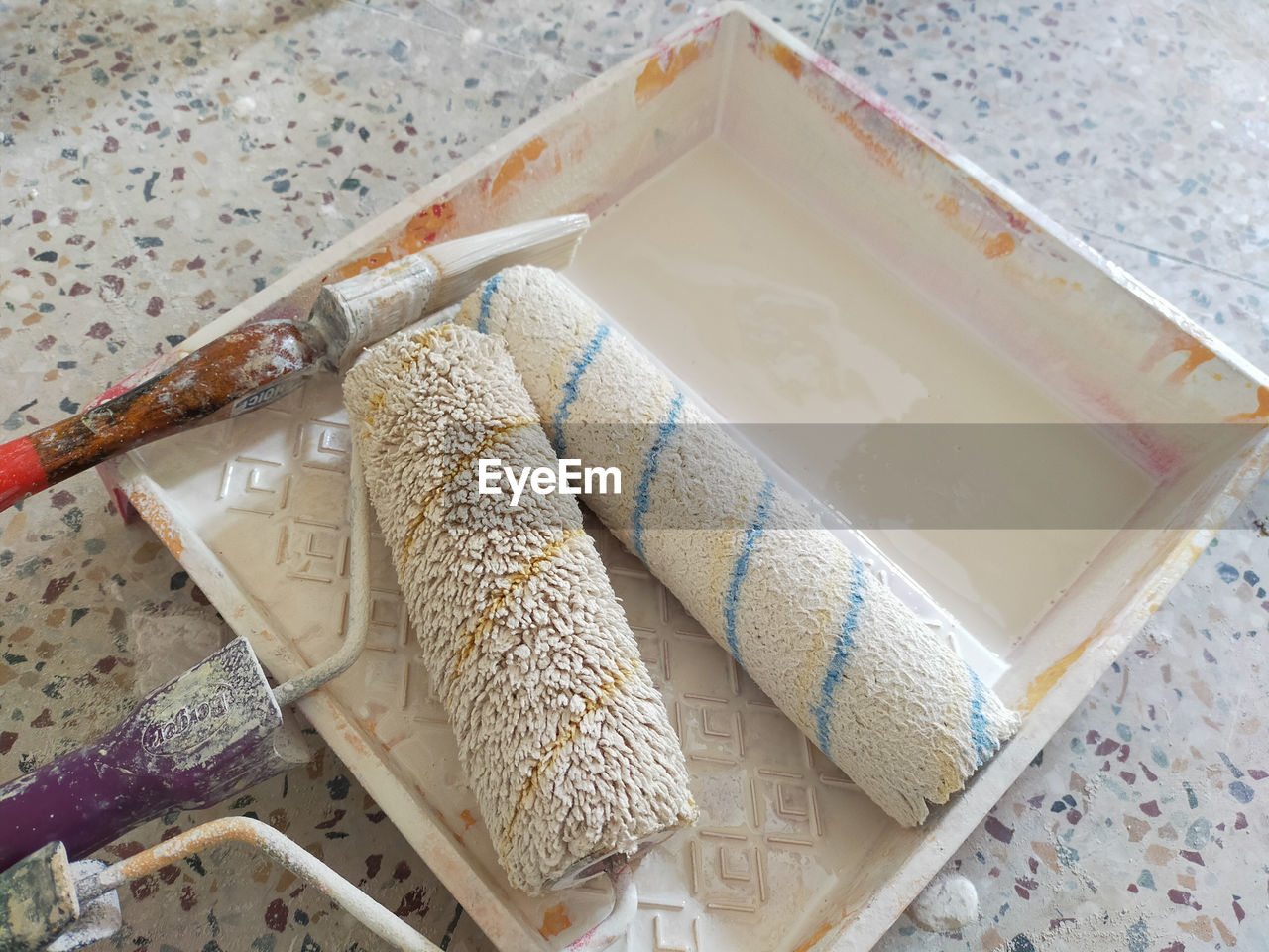 Various painting tools for home renovation on white background.