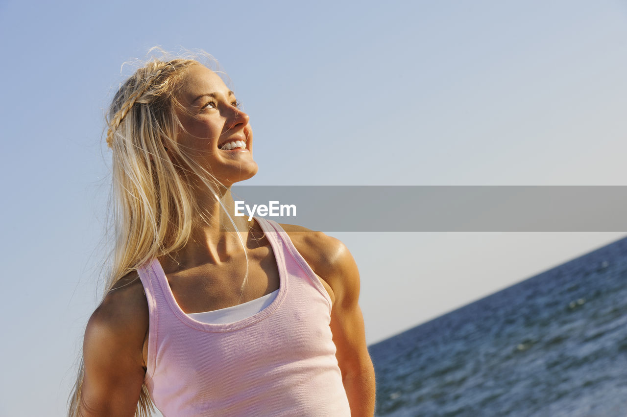 Smiling young woman looking away