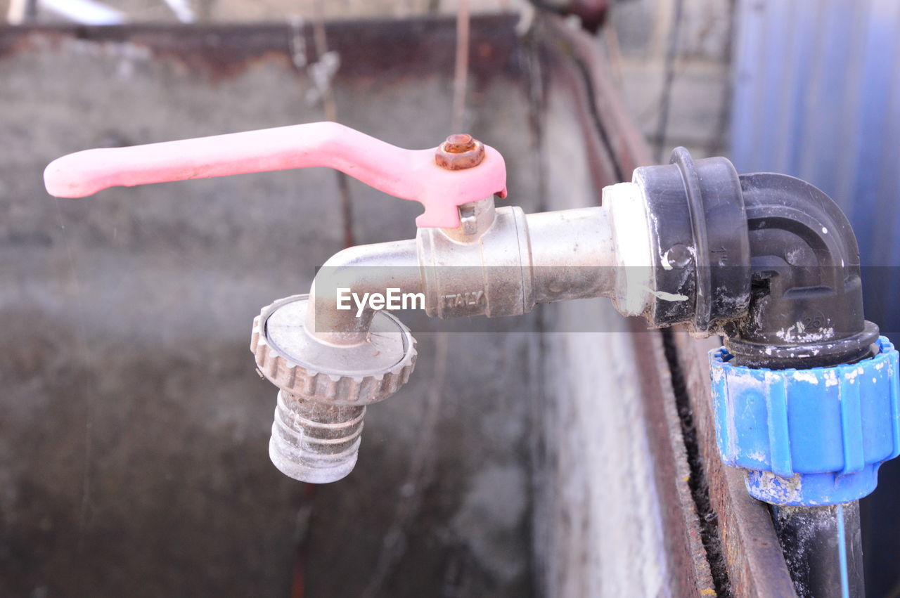 Close-up of faucet against blurred background