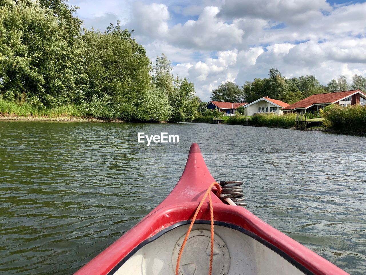 BOAT IN LAKE AGAINST SKY