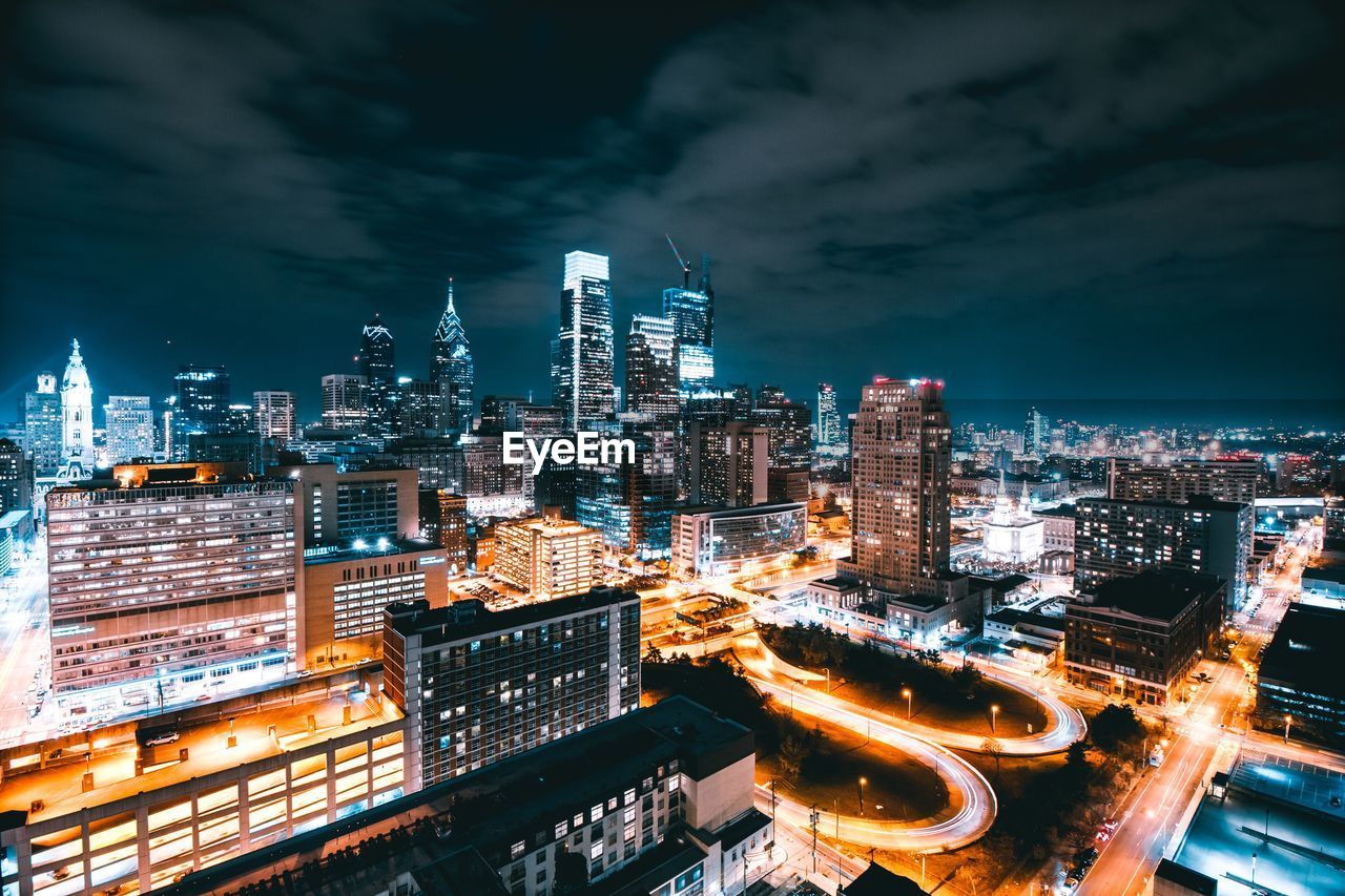 Illuminated cityscape against sky at night