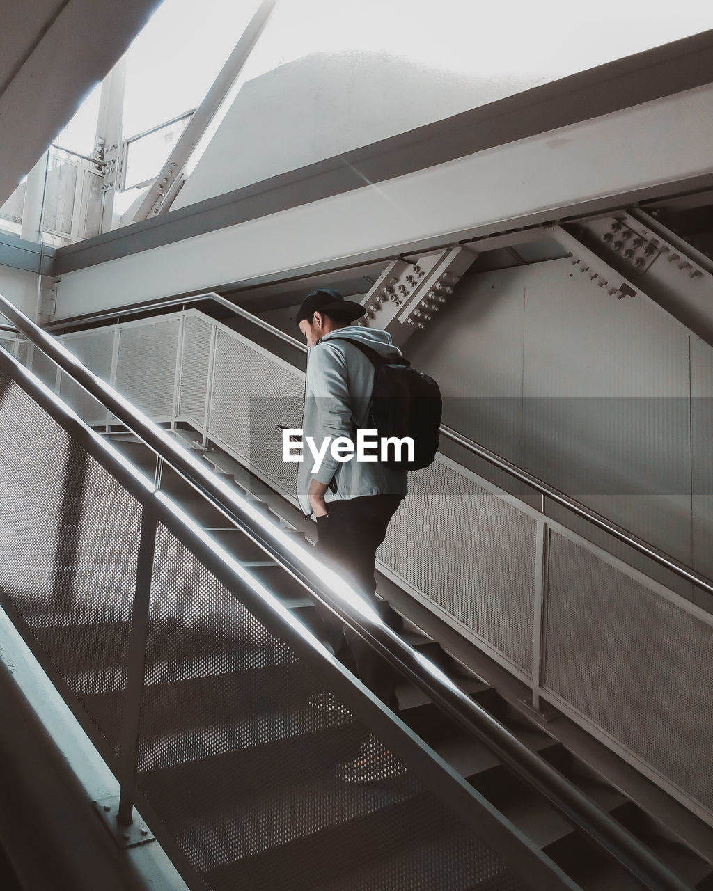 Low angle view of man standing on escalator