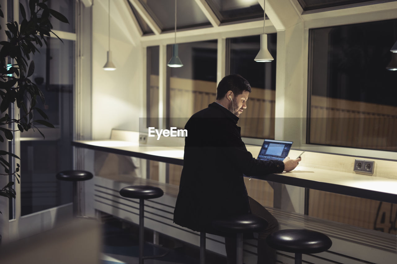 Man working with laptop in public space