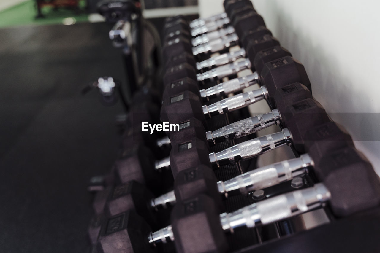 Dumbbells arranged in a line at health club
