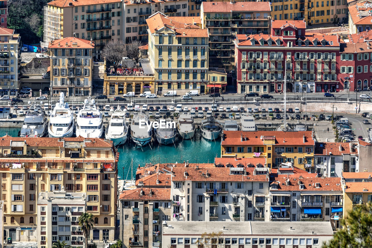 Aerial view of boats moored at harbor in city