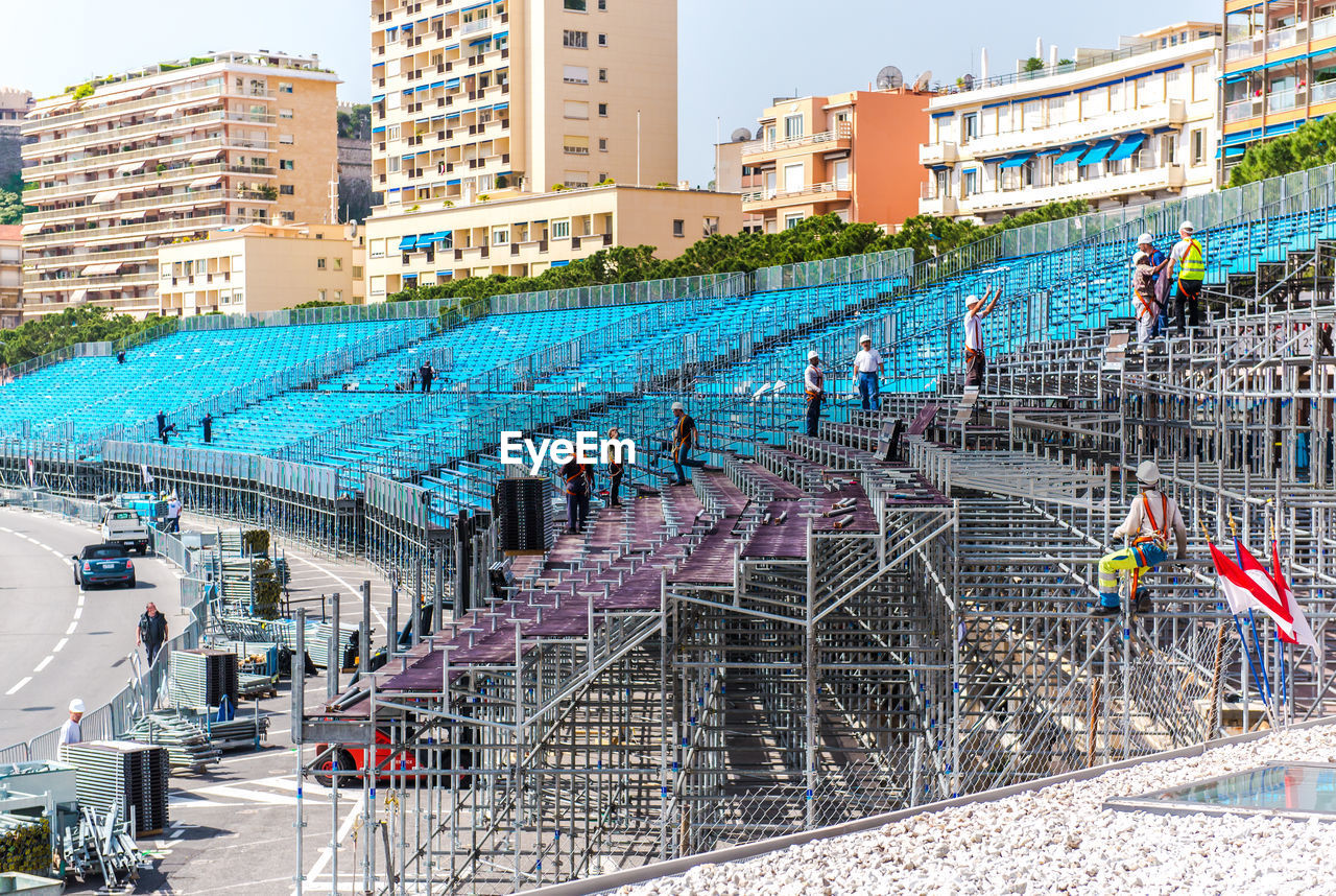 Workers arranging seats on stadium