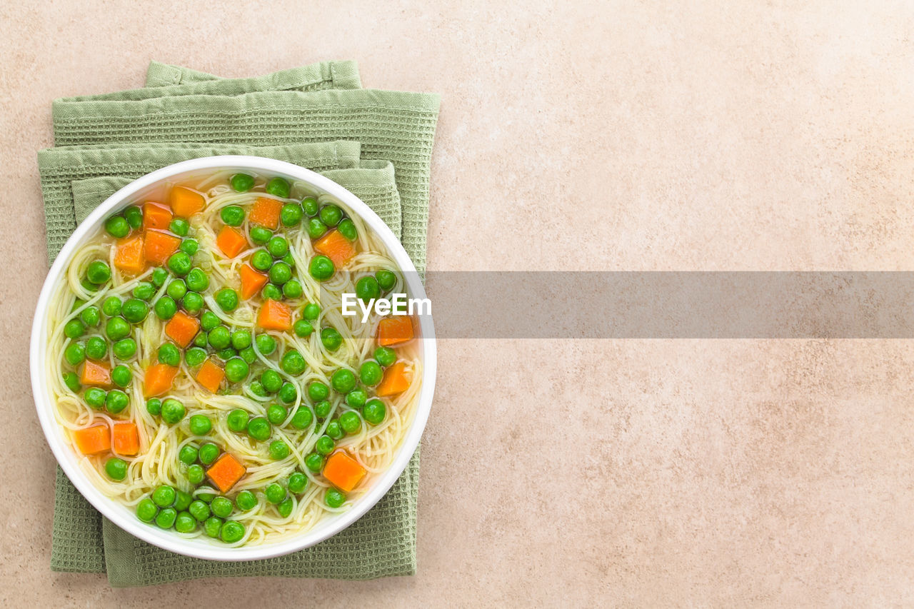 DIRECTLY ABOVE SHOT OF SOUP IN BOWL AGAINST WALL