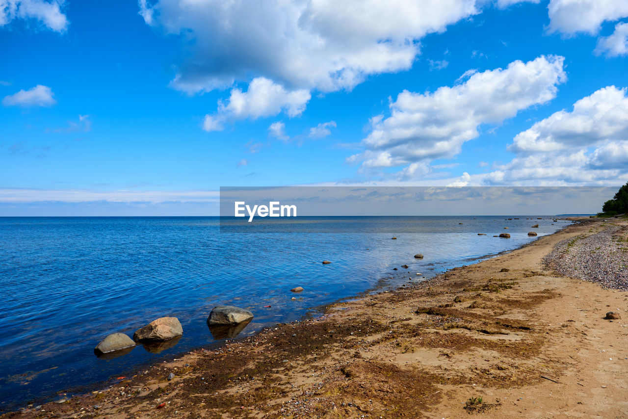 Scenic view of sea against cloudy sky