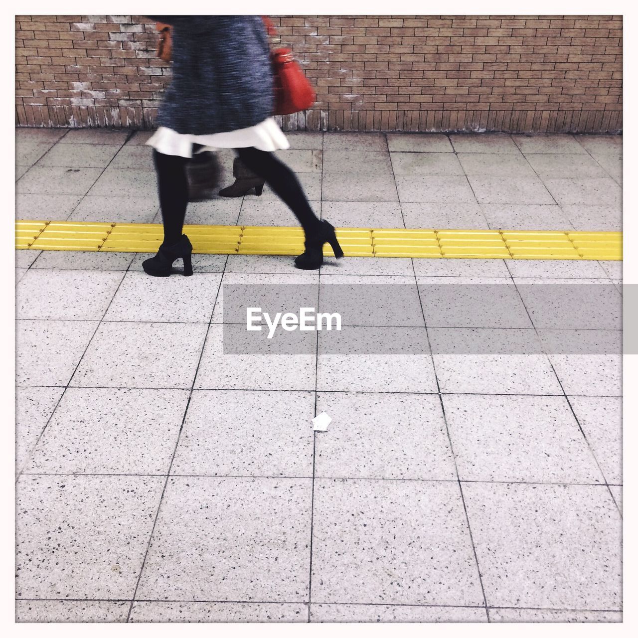 Low section of man walking on zebra crossing