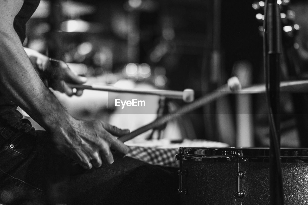 Close-up of drummer at music concert