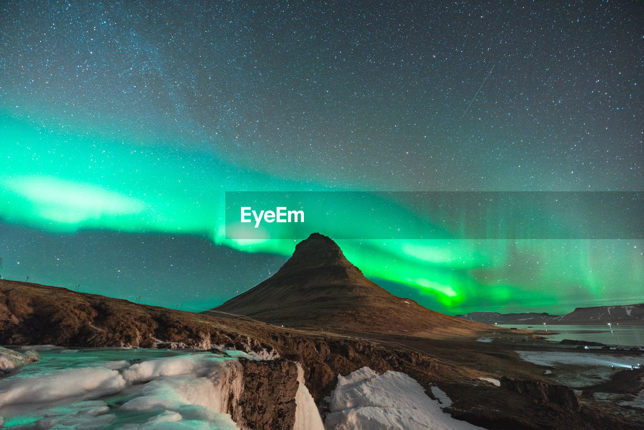 Scenic view of mountain against sky at night