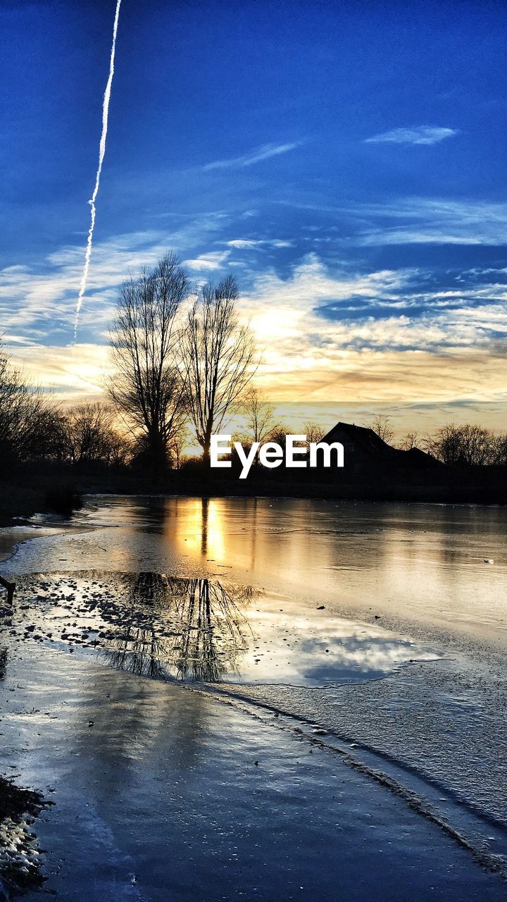 Scenic view of lake against sky during sunset