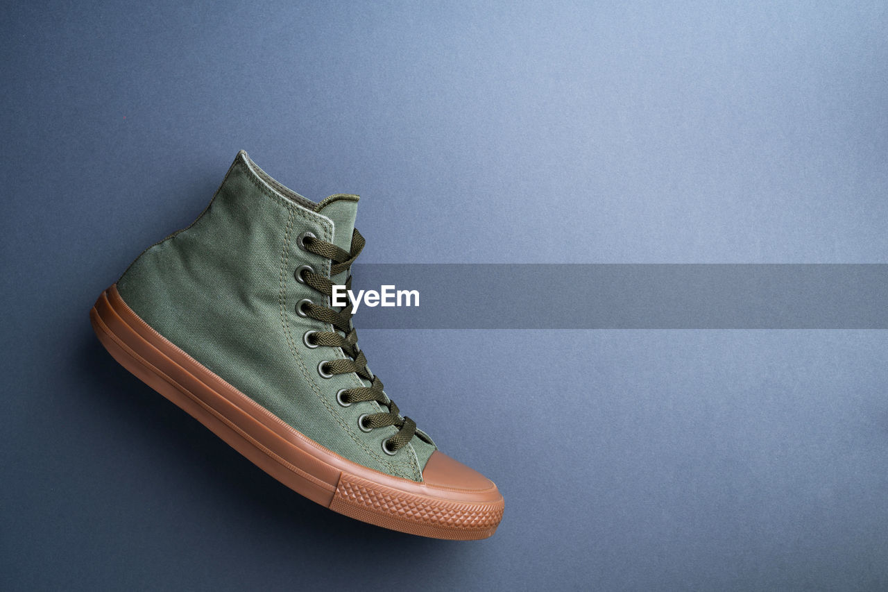 Directly above shot of shoe over blue background