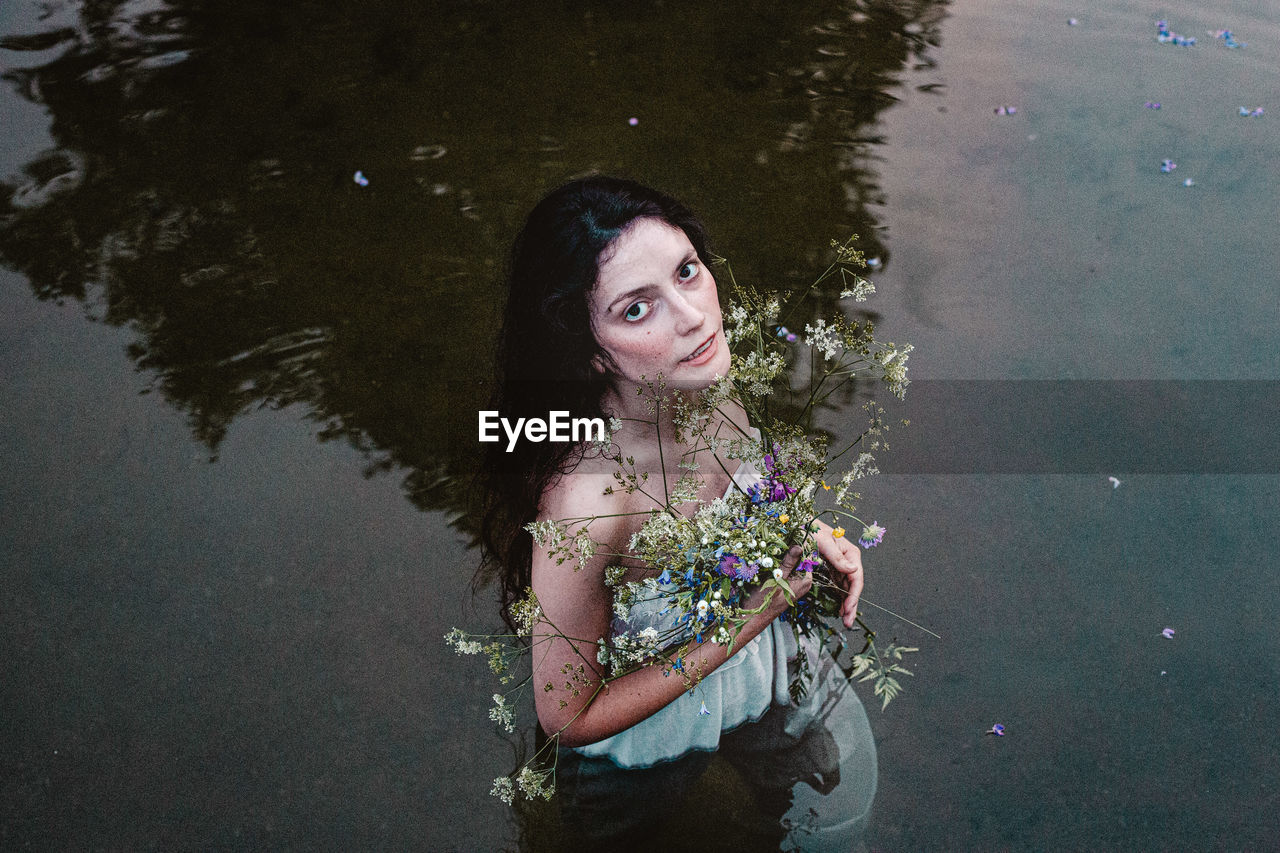 High angle portrait of woman standing in the lake