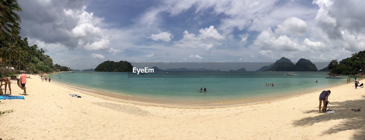 PANORAMIC VIEW OF PEOPLE ON BEACH