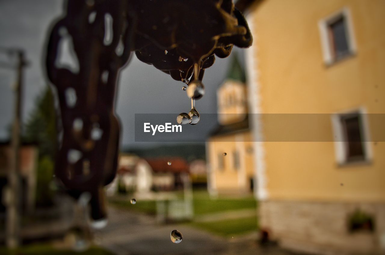 CLOSE-UP OF WATER DROPS ON METAL STRUCTURE