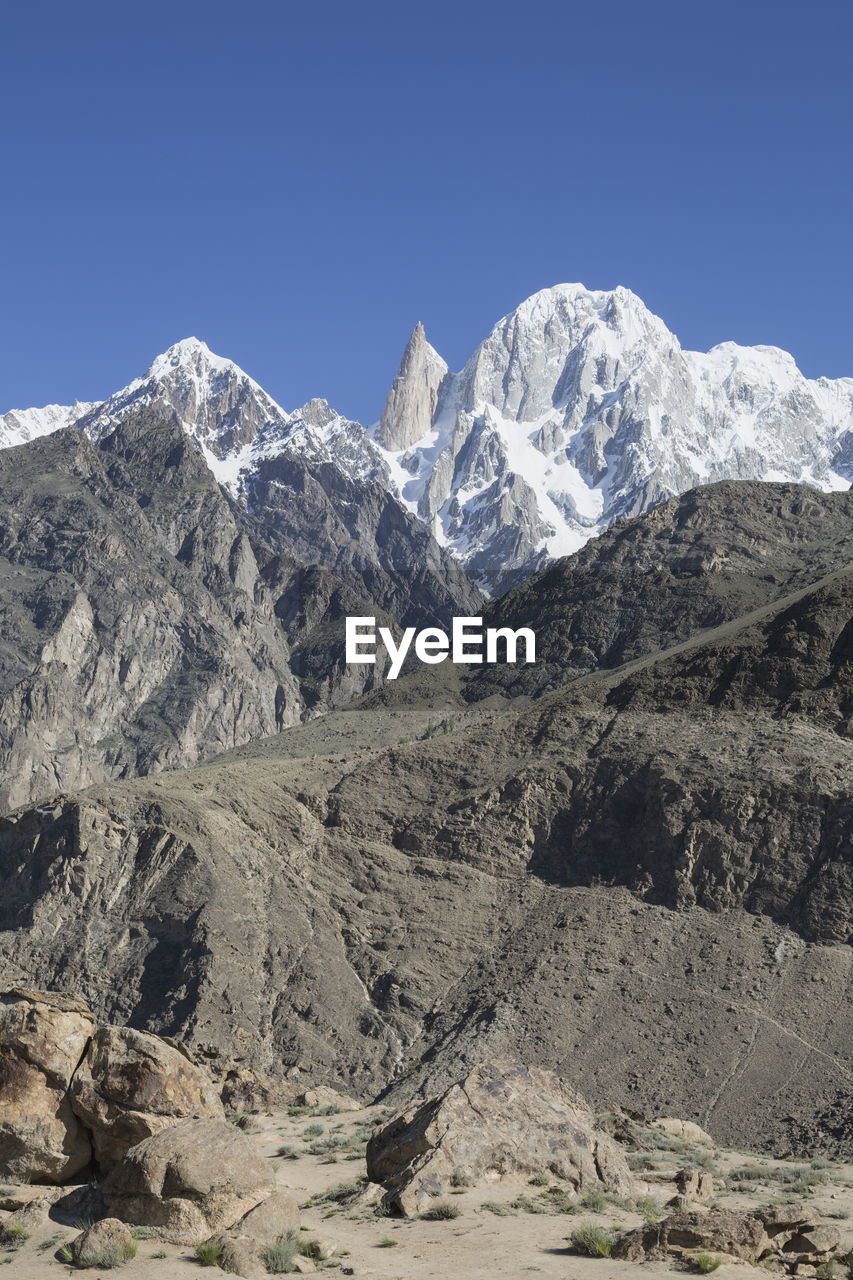 Scenic view of snowcapped mountains against clear sky