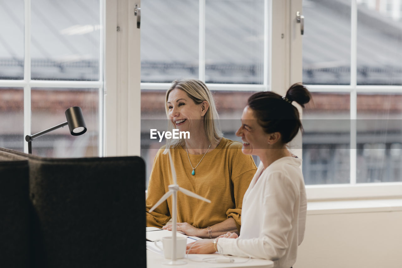 Smiling businesswomen working at desk in office