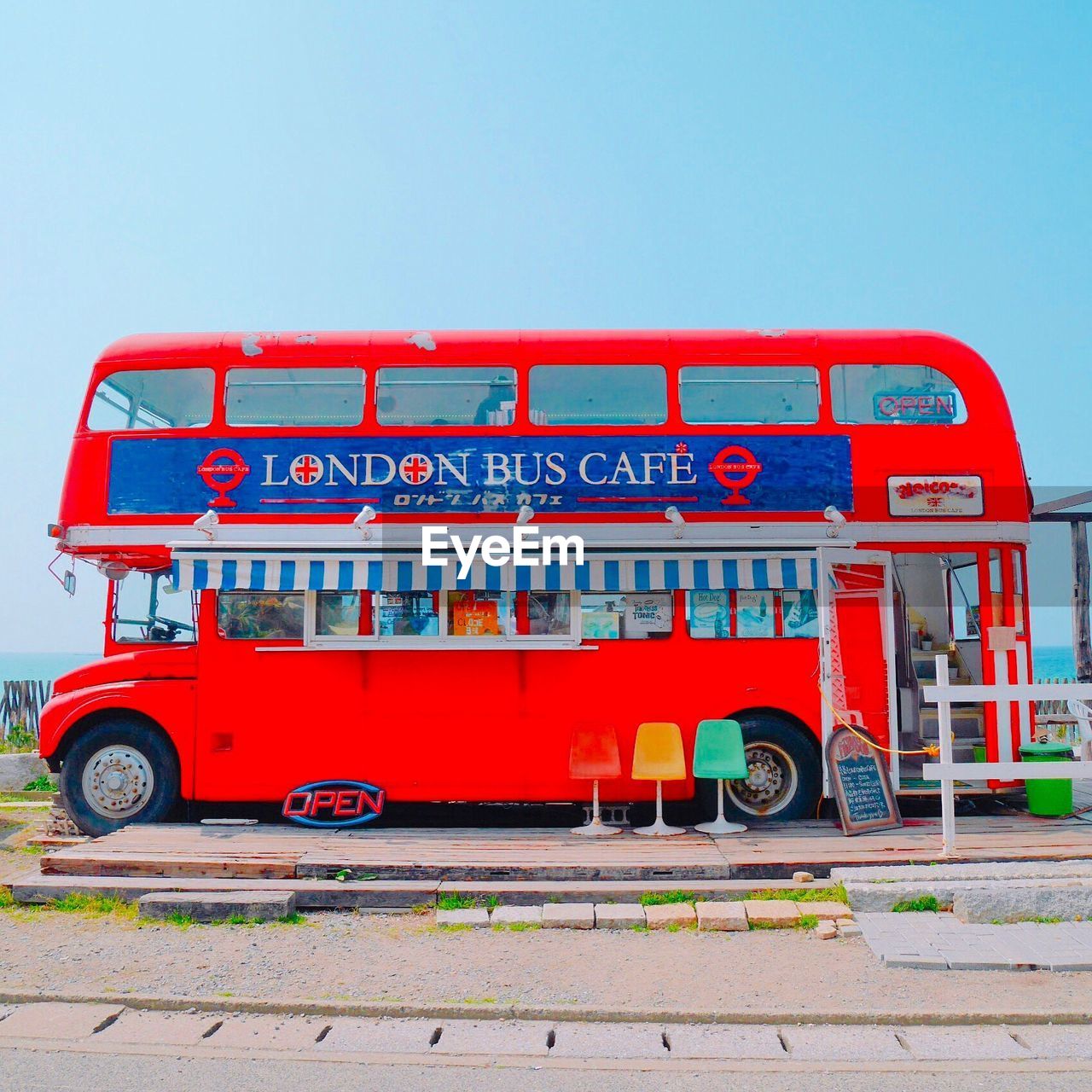 RED VINTAGE CAR AGAINST SKY