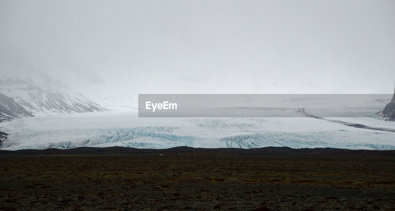 Idyllic shot of frozen landscape against sky