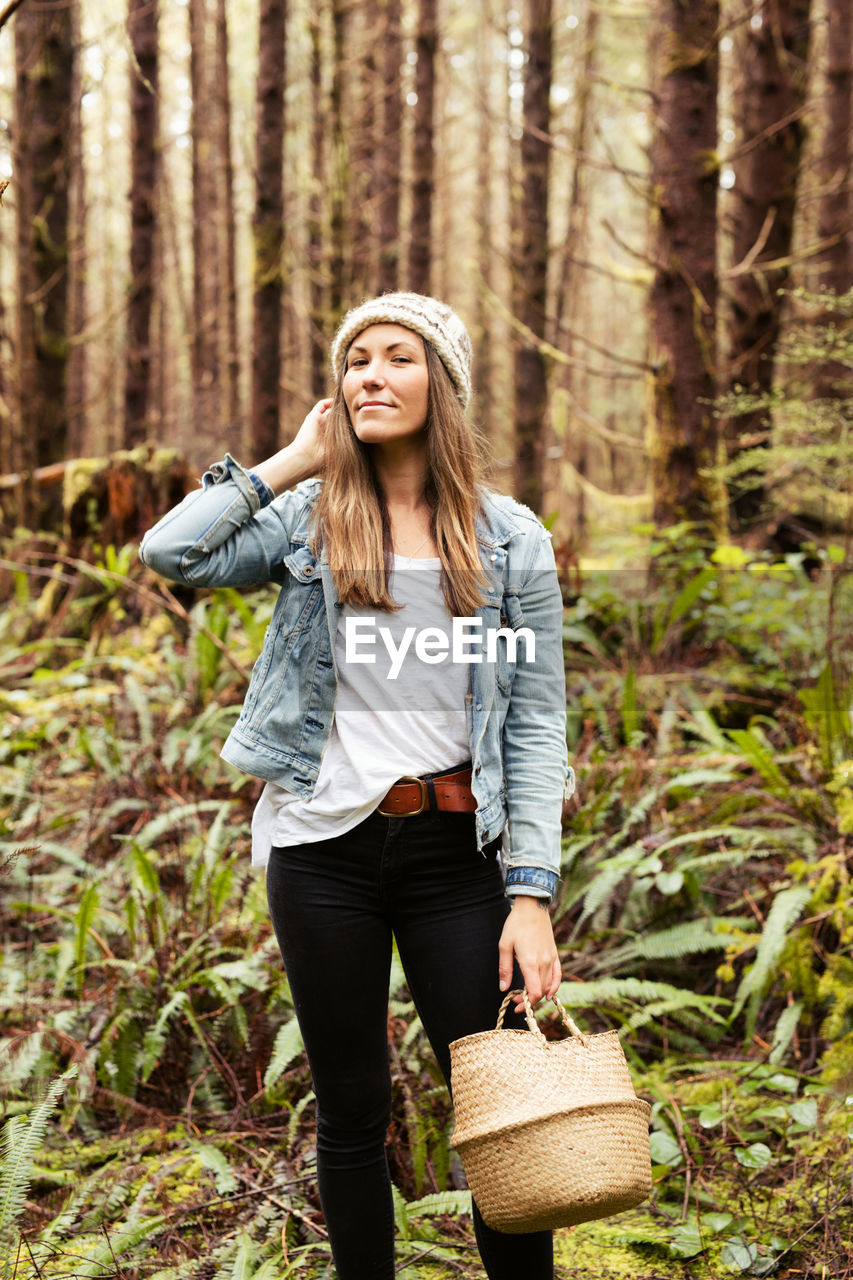 Beautiful woman forages in the rainforest near tofino