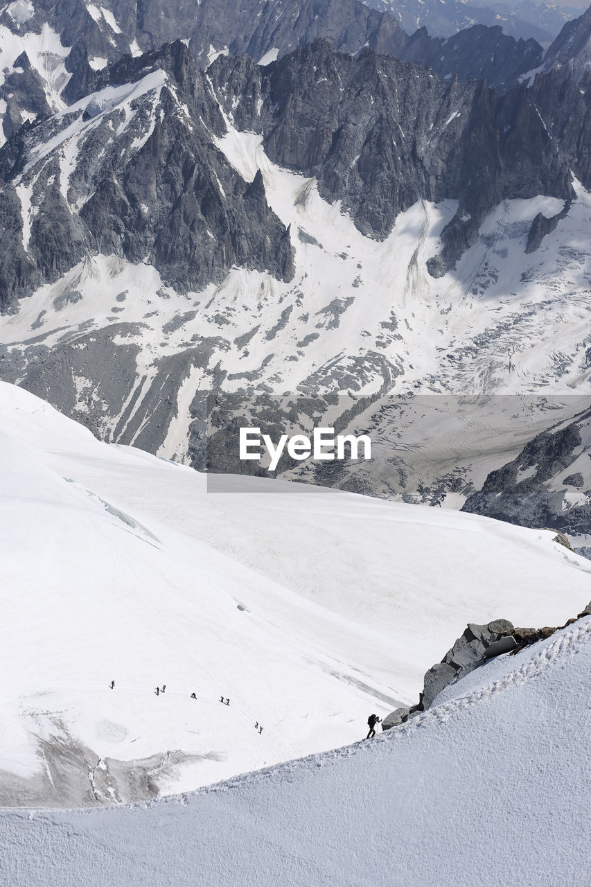 Views from la'aiguille du midi in chamonix, france. in the image climbers ascending mont blanc 