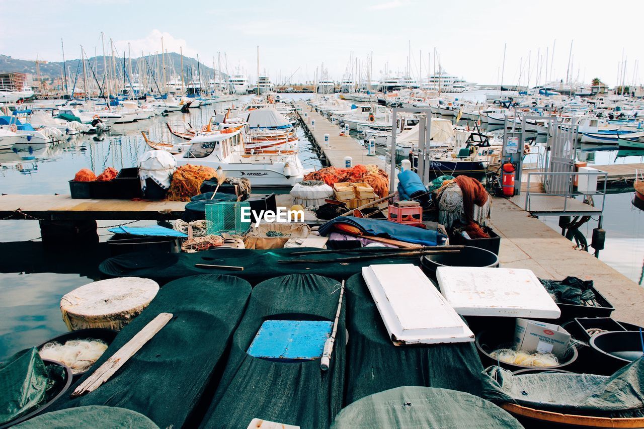 HIGH ANGLE VIEW OF SAILBOATS MOORED AT HARBOR