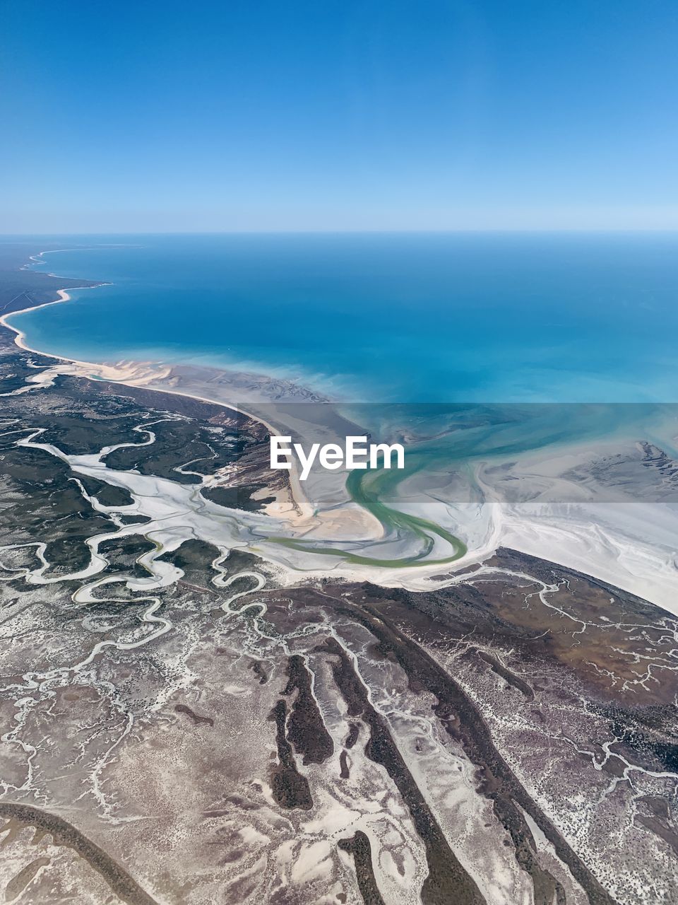 High angle view of sea against clear blue sky