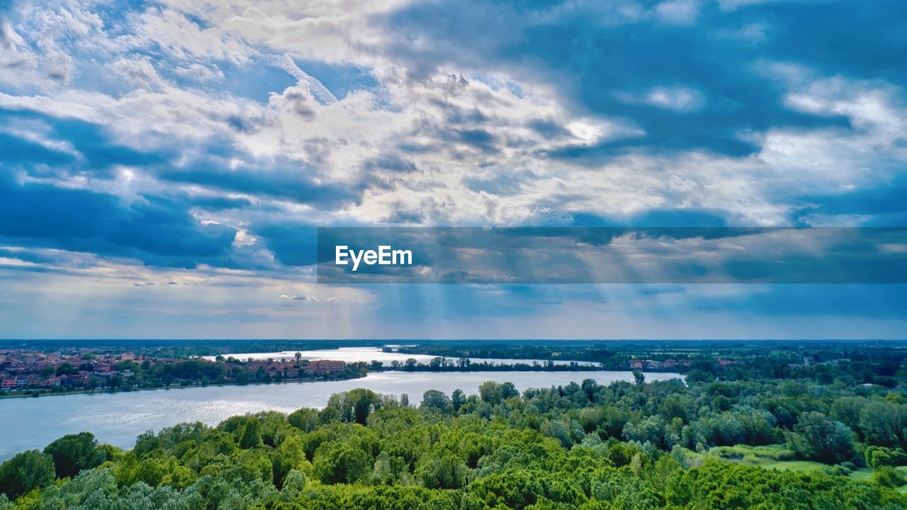 SCENIC VIEW OF SEA AND TREES AGAINST SKY