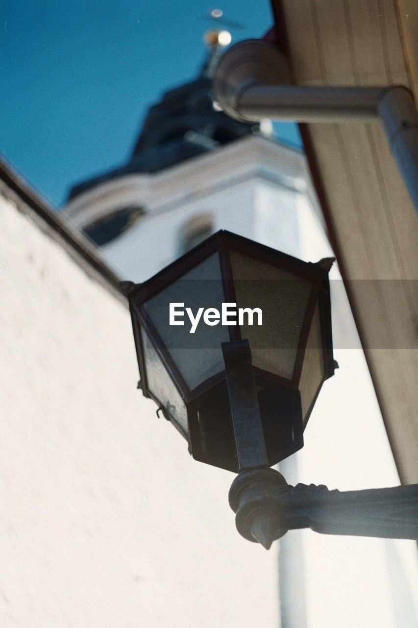 LOW ANGLE VIEW OF ILLUMINATED LAMP ON BUILDING