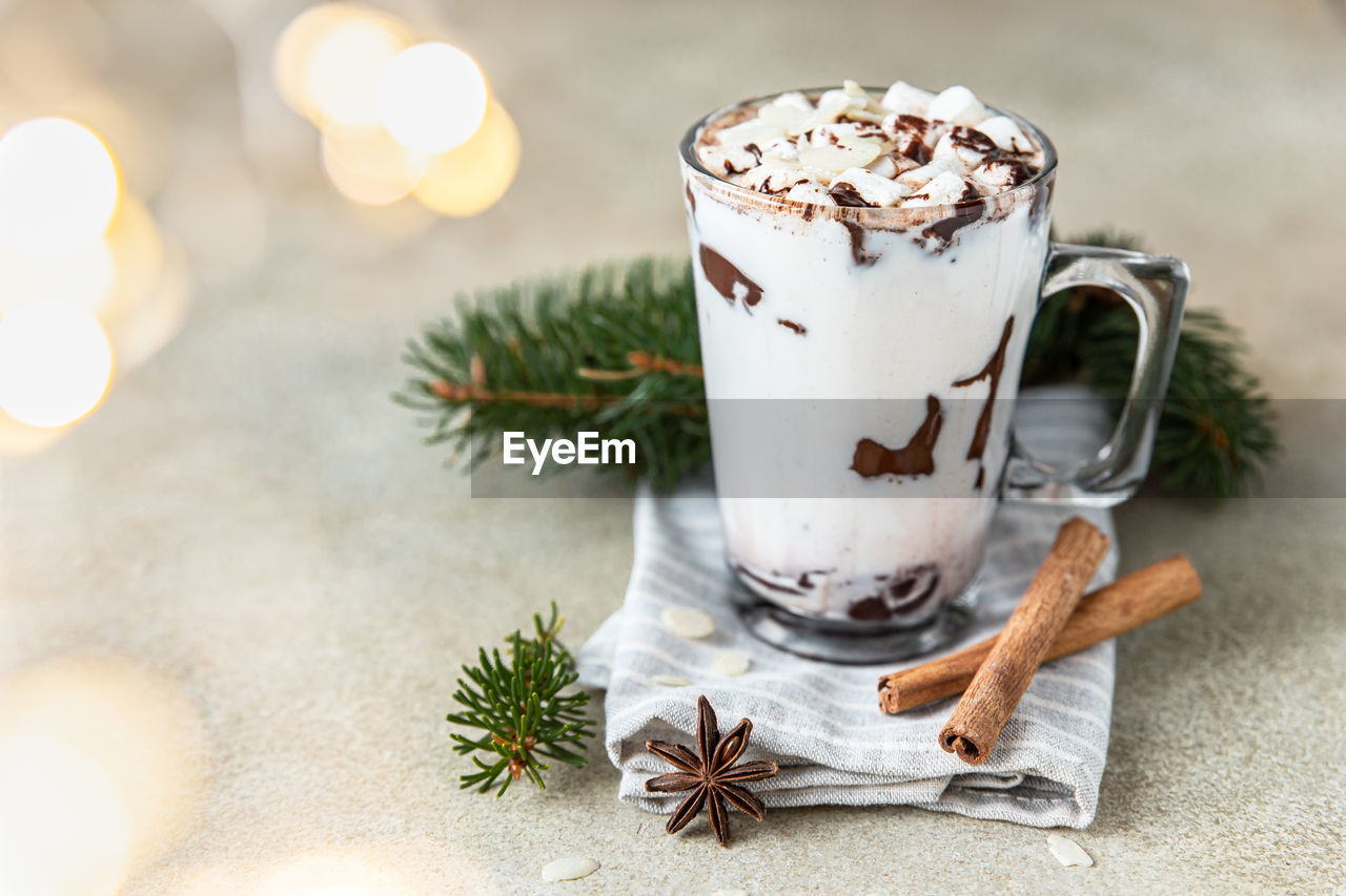 Hot chocolate or cocoa drink with marshmallow. winter holiday composition with garland.