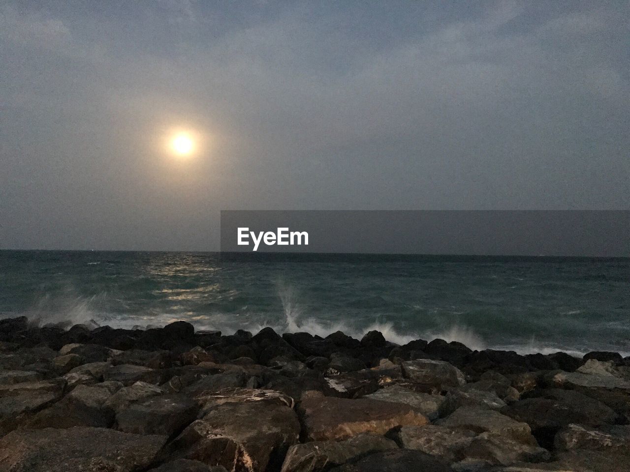 SCENIC VIEW OF BEACH AGAINST SKY AT NIGHT