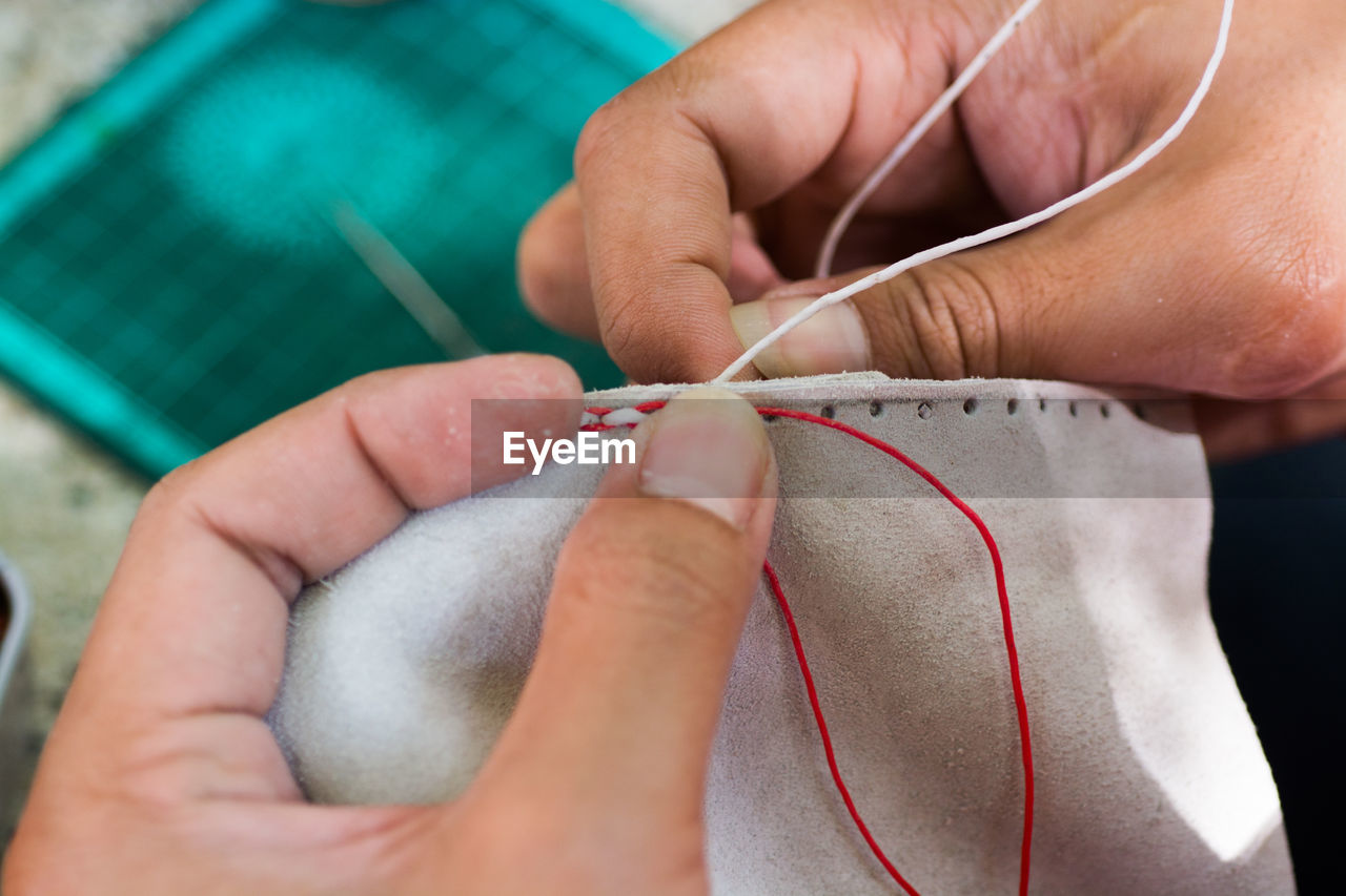 Close-up of hands sewing fabric