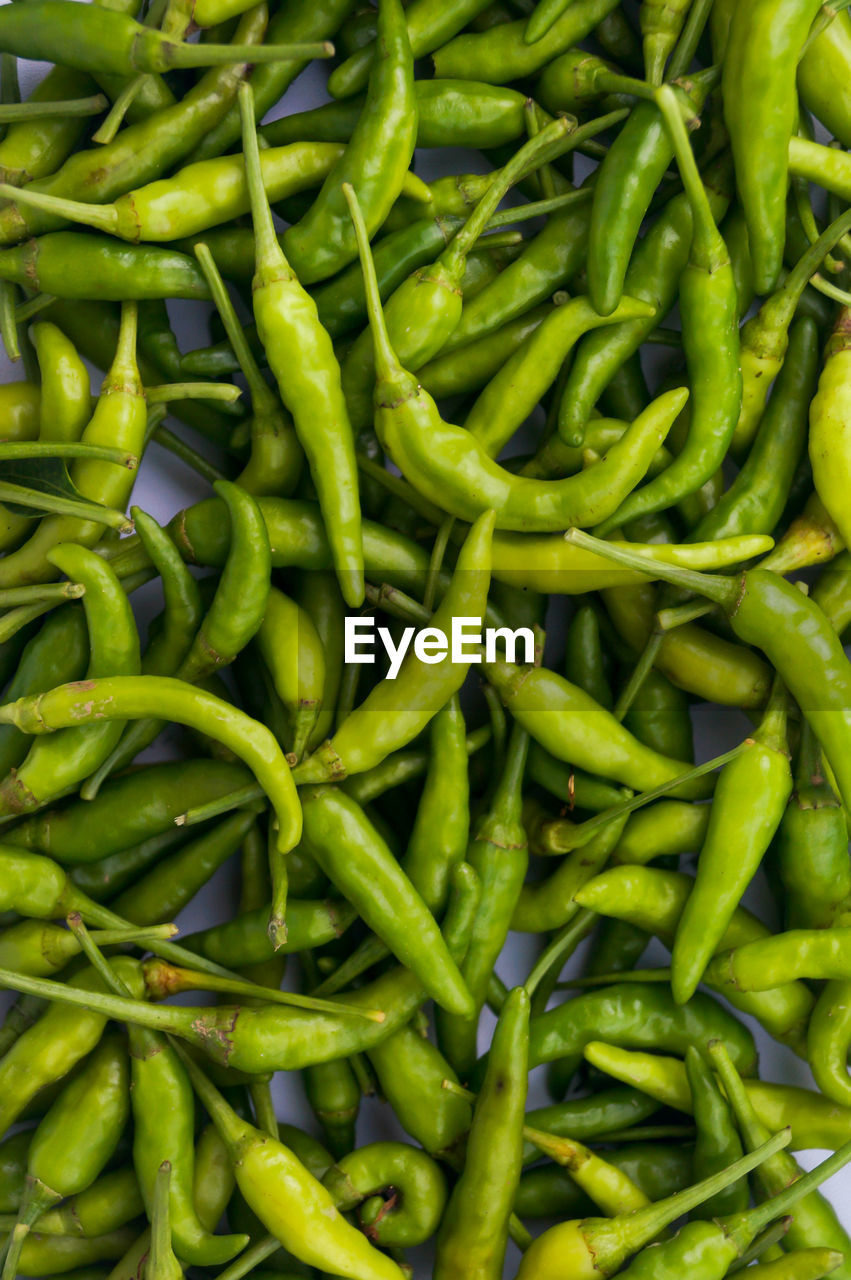 FULL FRAME SHOT OF GREEN CHILI PEPPERS AT MARKET