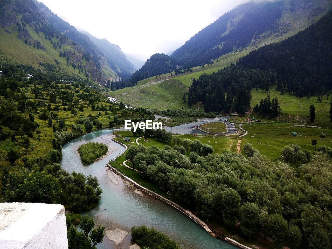 HIGH ANGLE VIEW OF RIVER AMIDST LANDSCAPE AGAINST SKY