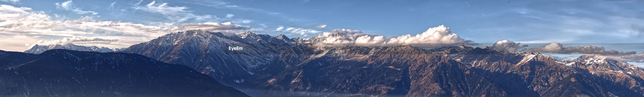 Panoramic view of snowcapped mountains against sky