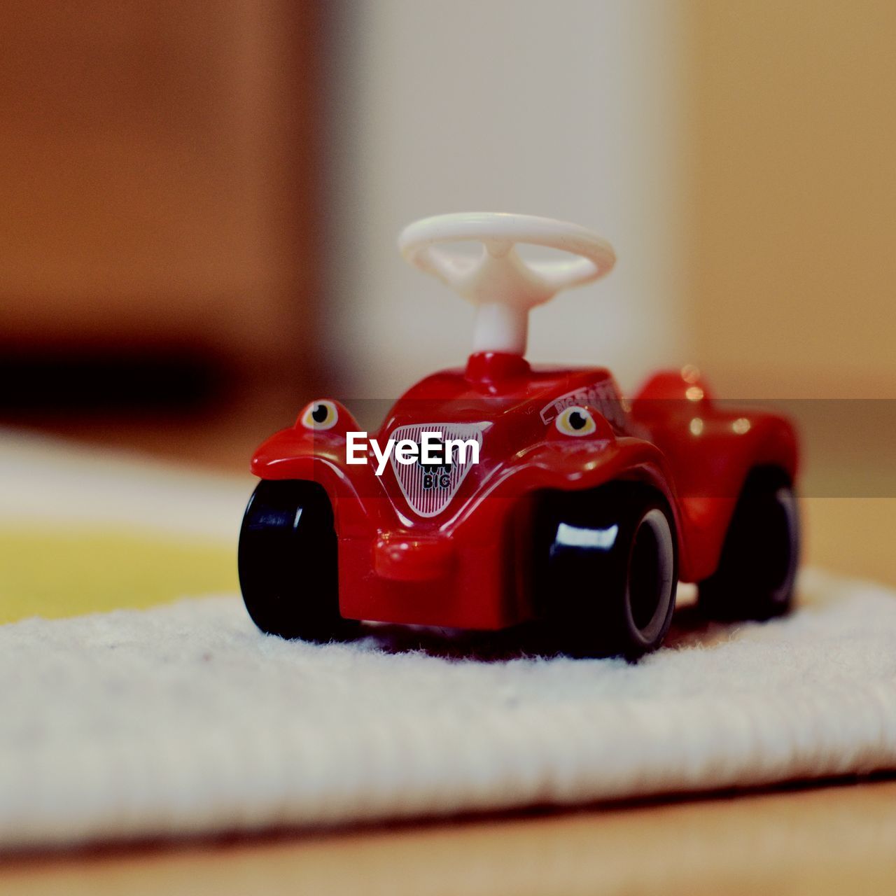 CLOSE-UP OF TOY CAR ON FLOOR