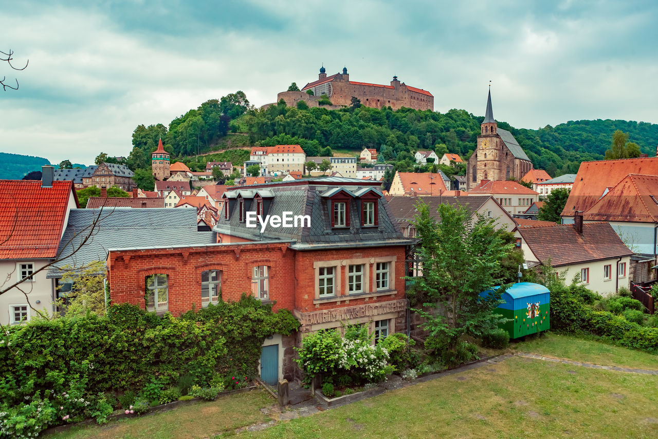 Buildings in town against sky