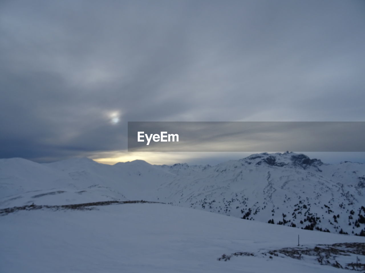 SNOW COVERED MOUNTAINS AGAINST SKY