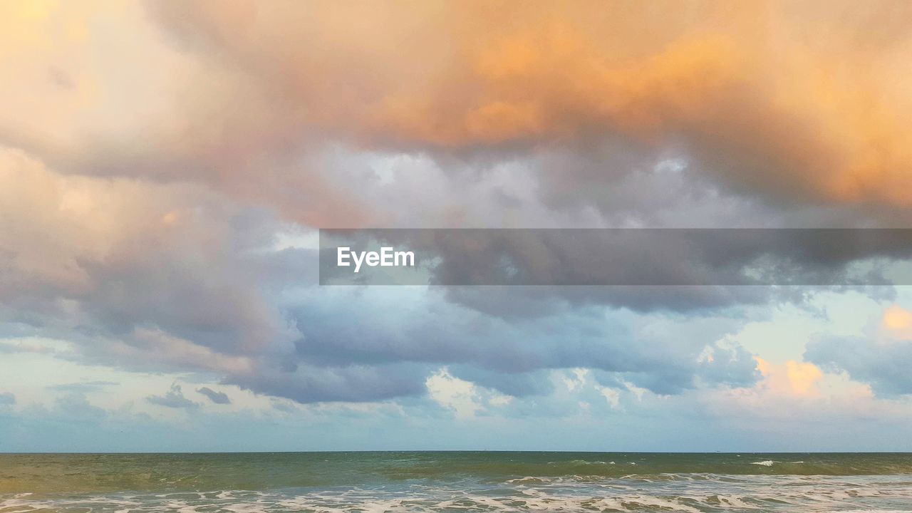 SEA AGAINST CLOUDY SKY