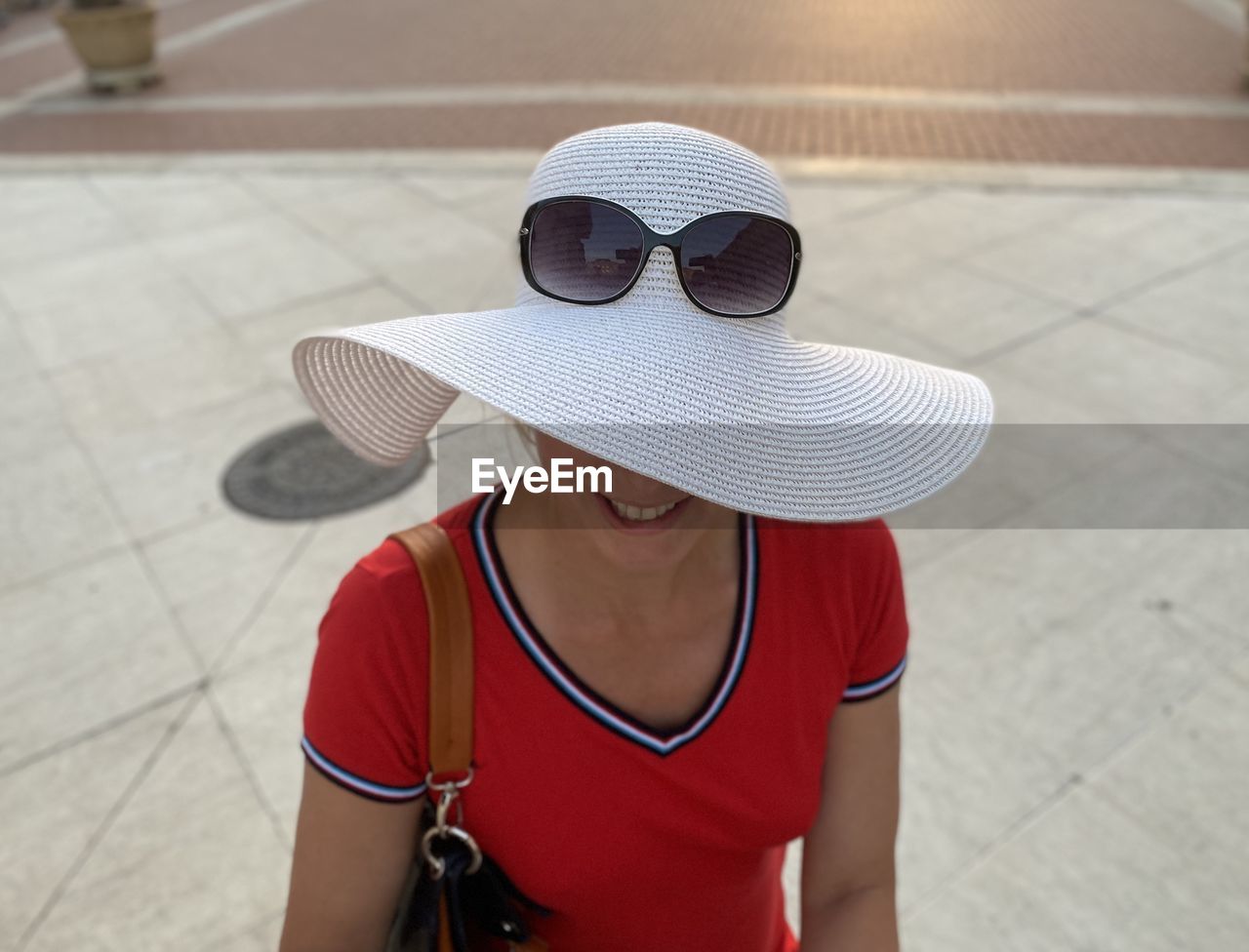 High angle view of cheerful woman wearing hat