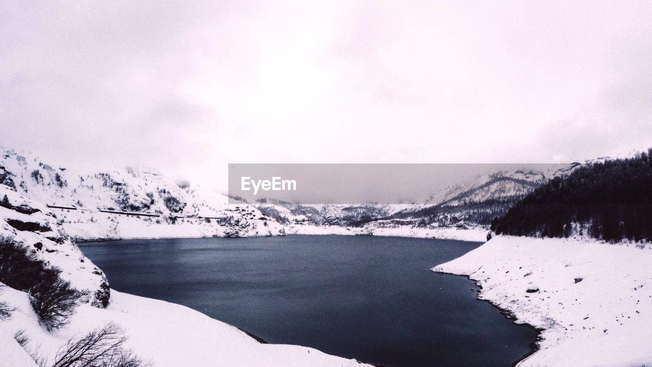 Scenic view of mountains against cloudy sky