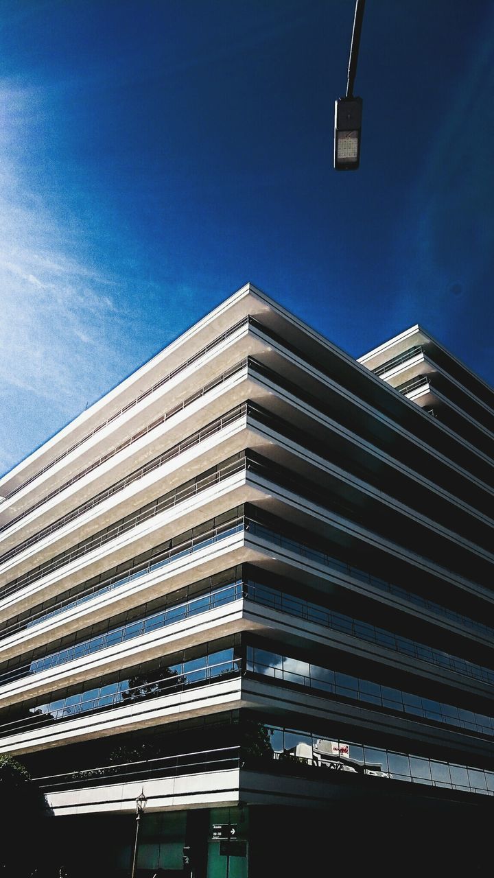 Low angle view of building against cloudy sky